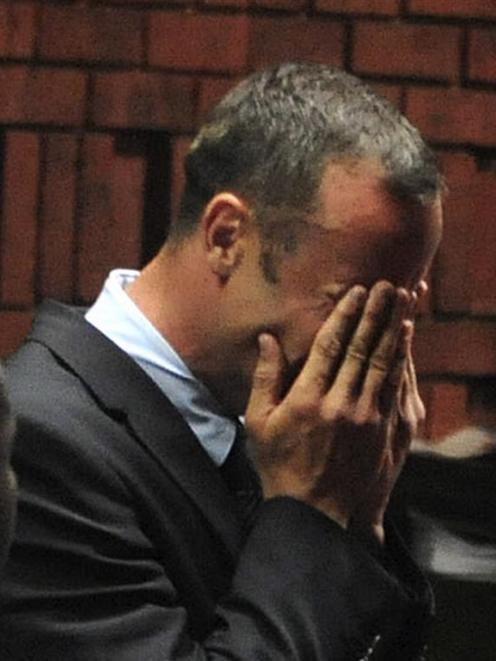 Oscar Pistorius breaks down during his court appearance in Pretoria. REUTERS/Antonie de Ras