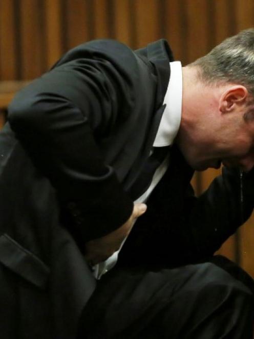 Oscar Pistorius is overcome by emotion during his trial at the high court in Pretoria. REUTERS...