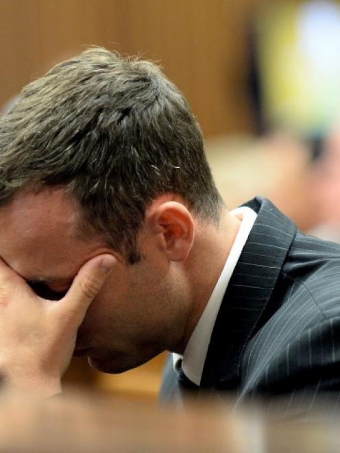 Oscar Pistorius reacts as he hears a testimony at the North Gauteng High Court in Pretoria....