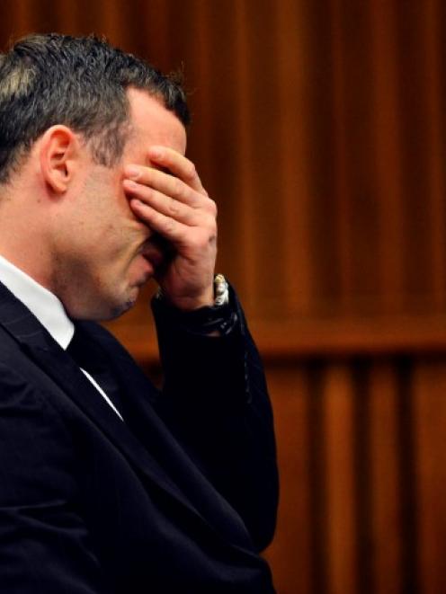 Oscar Pistorius reacts in the dock during his murder trial at the North Gauteng High Court in...