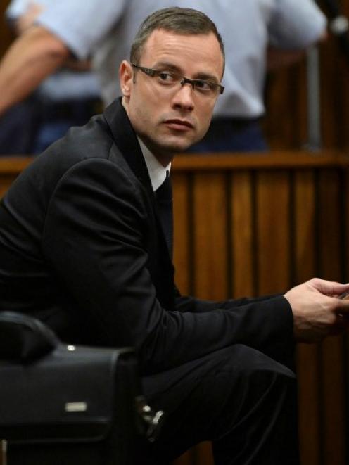 Oscar Pistorius sits in the dock during court proceedings at the North Gauteng High Court in...