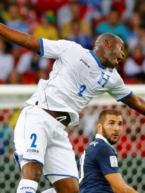 Osman Chavez (L) of Honduras jumps for the ball past France's Karim Benzema. REUTERS/Murad Sezer