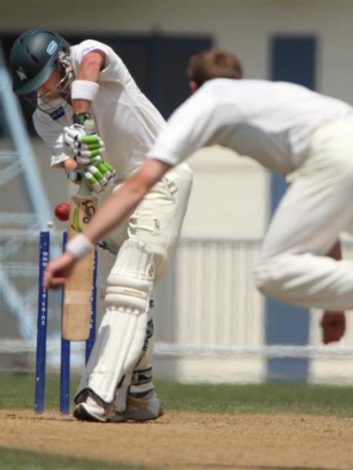 Otago bowler James McMillan skittles Central Districts batsman Tim Weston at Napier yesterday....