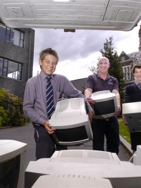 Otago Boys High School pupils Michael Ryan (13, left) and Ben Harrison (13) help Equico general...