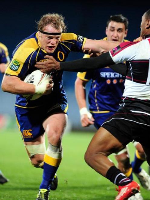Otago captain Eben Joubert heads for the tryline in the tackle of North Harbour wing David...