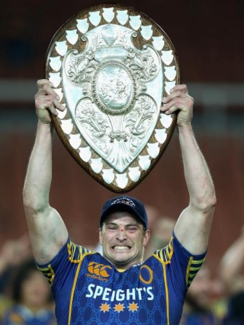 Otago captain Paul Grant holds the Ranfurly Shield aloft after his team beat Waikato in Hamilton...