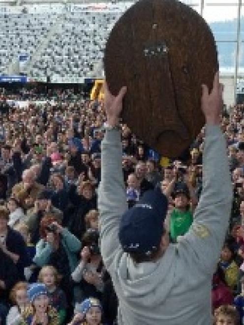 Otago captain Paul Grant raises the Ranfurly Shield to the delight of thousands of fans at...