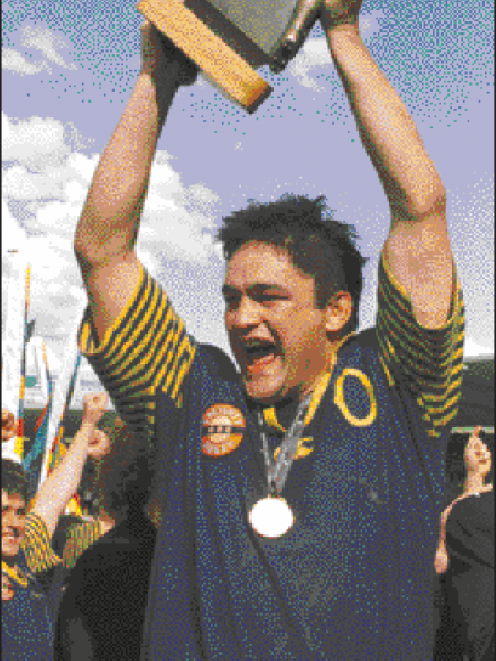 Otago captain Taine Randall holds aloft the National Provincial Championship trophy after his...