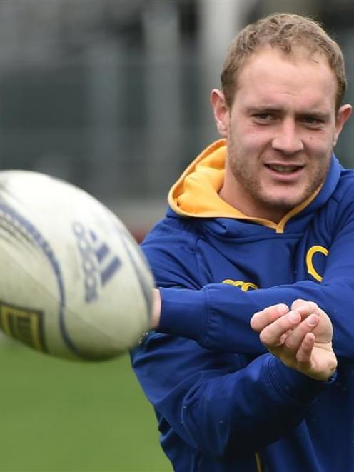 Otago centre Matt Faddes fires off a pass during team training on Tuesday. Photo by Gregor...