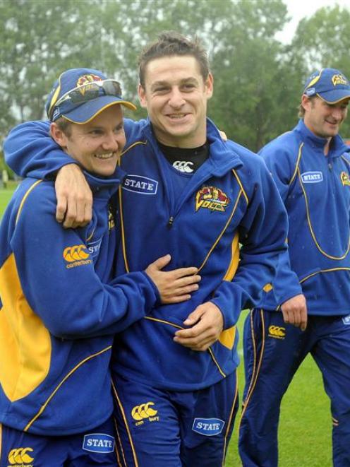 Otago coach Mike Hesson (left) and all-rounder Nathan McCullum celebrate after the State twenty...