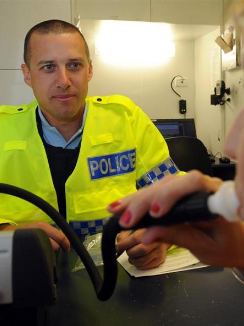 Otago Daily Times reporter Lea Jones takes part in a mock breath test for Constable Patrick...