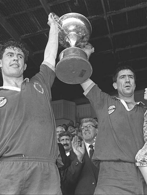 Otago forwards Mike Brewer (left) and Richard Knight celebrate with the trophy after sealing...