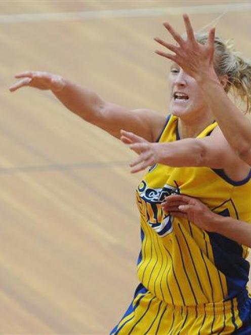 Otago Goldrush forward Patrice McKenzie fires off a pass between Harbour Breeze guard Chelsea...
