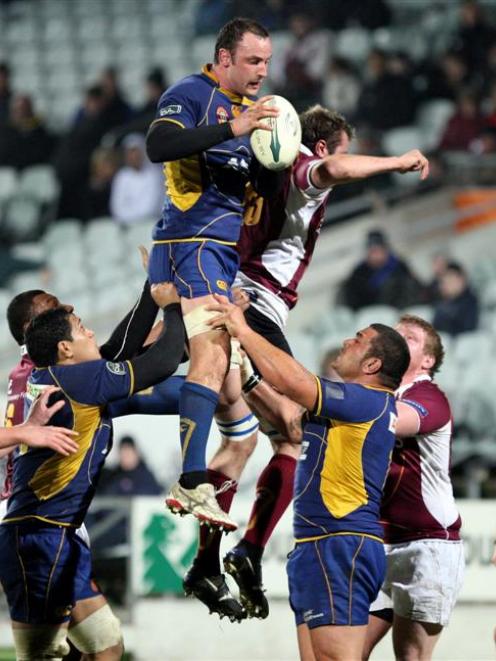 Otago lock Hayden Triggs, lifted by No 8 Steven Setephano (left) and prop Kees Meeuws, goes high...