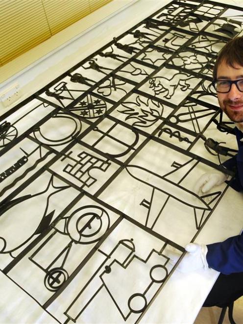 Otago Museum humanities collection co-ordinator Scott Reeves looks at a large sculptural mural by...