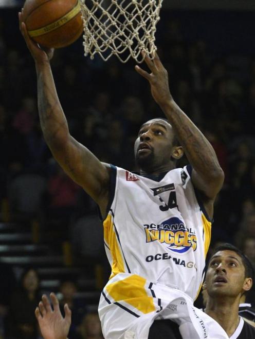 Otago Nugget number 34 Akeem Wright scores while watched by Super City Rangers number 15 Johnny...