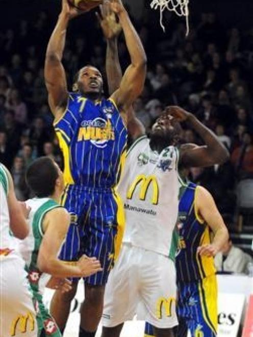 Otago Nuggets forward John Barber jun looks for the shot above Manawatu Jets defender Richard...