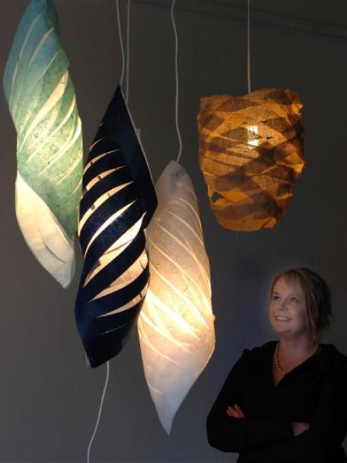 Otago Polytechnic design student Juliet Symes looks at her light design, Waste Not, created for a...