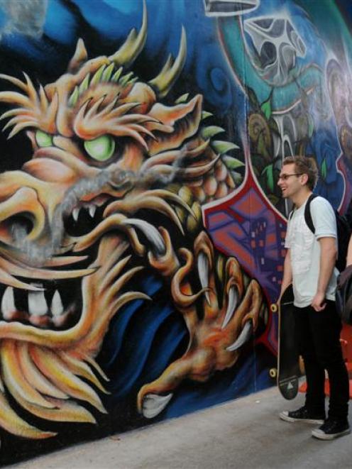 Otago Polytechnic School of Arts students Aaron McMillan and Mel Giles admire the mural in Hoyts...