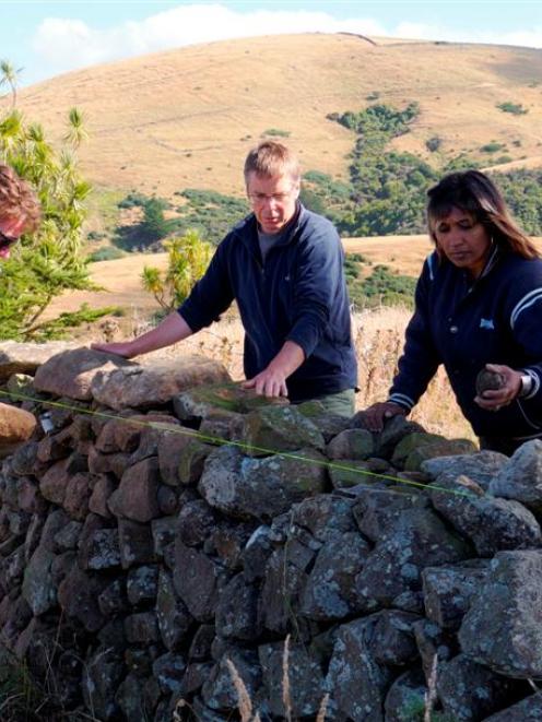 Otago Polytechnic stonemasonry lecturer Steve Holmes (centre) supervises certificate in...