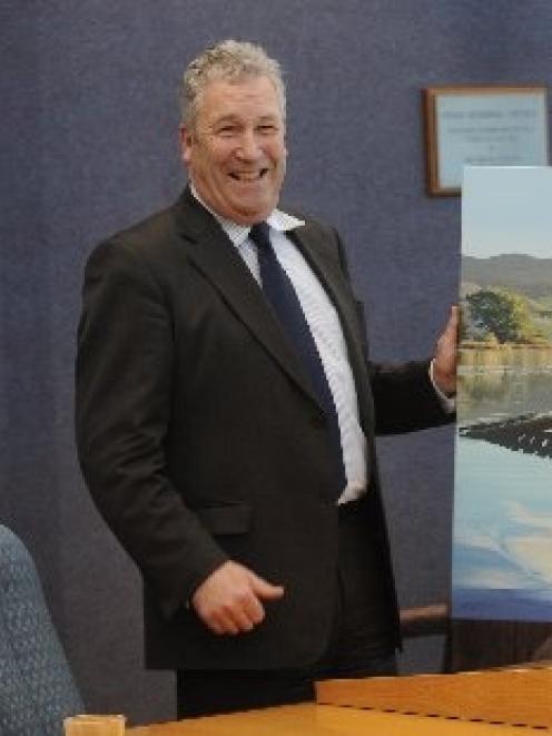 Otago Regional Council chairman Stephen Cairns with the painting of Purakaunui by Sheryl McCammon...