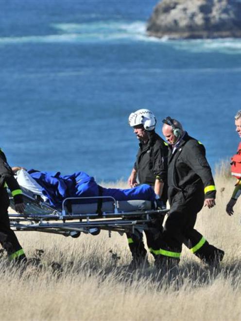 Otago Regional Rescue Helicopter crew move a hypothermic fisherman to a waiting Helicopters Otago...