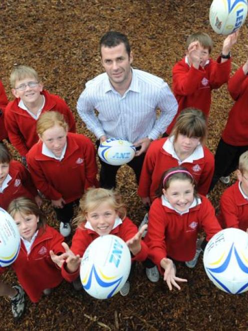 Otago Rugby Football Union commercial manager Mike Kerr with Fairfield School pupils to celebrate...