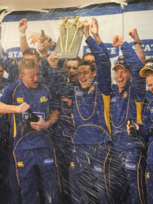 Otago's cricketers celebrate winning the twenty/20 title at University Oval yesterday. Photo by...