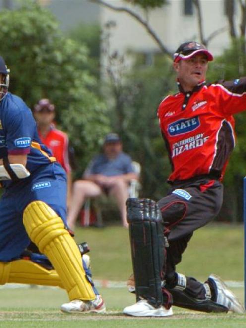 Otago's Nathan McCullum works the ball past Canterbury wicketkeeper Kruger van Wyk on his way to...