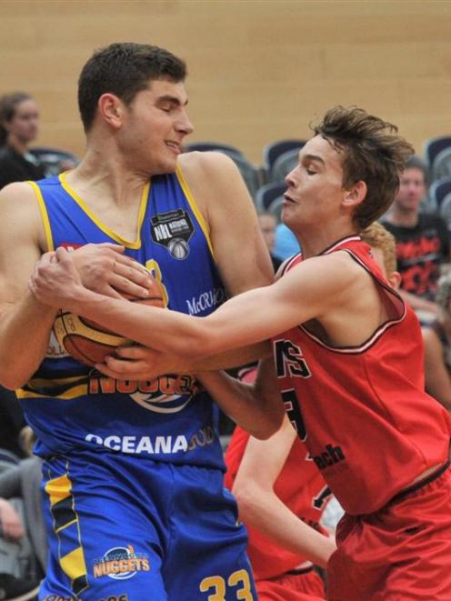 Otago's Sam Timmins is not giving the ball away to Canterbury's Taylor Britt without a fight...
