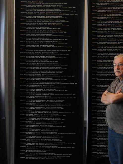 Otago Settlers Museum preparator Steve Munro stands in front of roll of honour panels being...