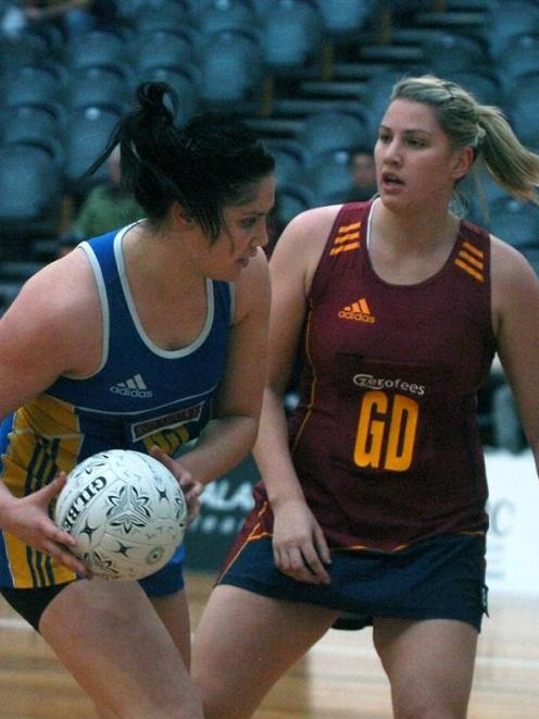 Otago shooter Te Paea Selby-Rickit looks for a way around her older sister, Southland defender Te...