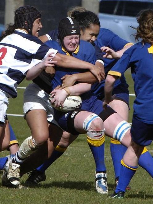 Otago Spirit lock Lisa Waddell is tackled by Auckland Storm prop Karina Penetito (left) and first...