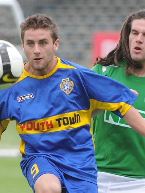 Otago United's Ryan Faichnie (left) is challenged by Manawatu's Nathan Cooksley during their New...