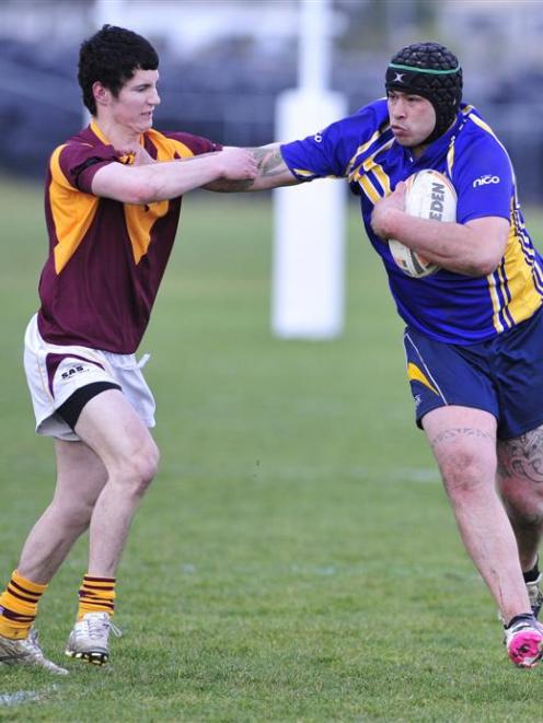 Otago Whalers forward Shane Unahi puts the fend on Southland Rams winger Zac Archer during the...