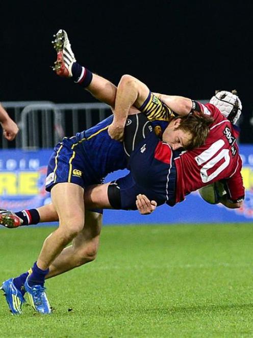 Otago wing Marshall Suckling slams into Tasman first five-eighth Hayden Cripps during their ITM...