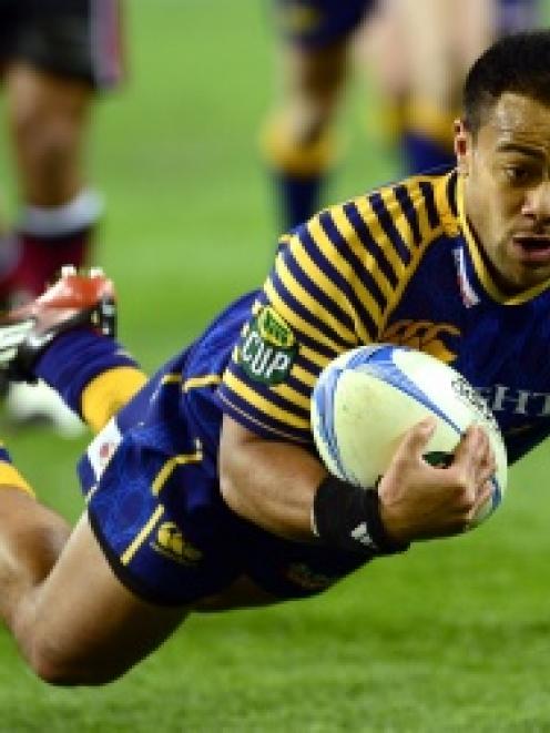 Otago winger Buxton Popoali'i launches himself over the tryline to score during the first half of...