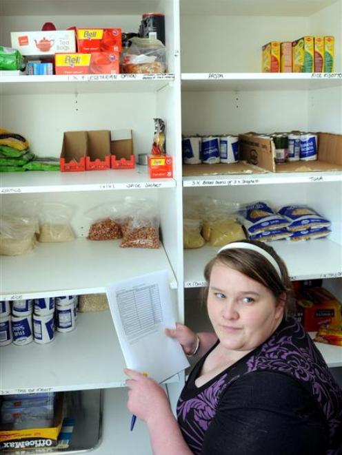 OUSA student support centre administrator Jessica Myers prepares a list to restock the foodbank....