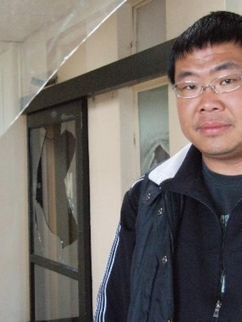 David Liu surveys smashed windows at the former Oamaru hospital. Photo by Sally Rae.