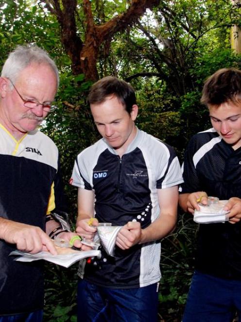 Owen (left), Tane and Ryan Cambridge practise map reading in Dunedin. Photo by Gregor Richardson.