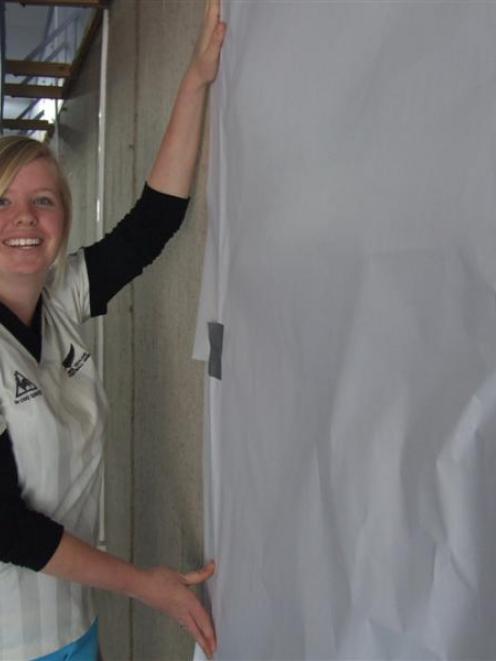 Waitaki District Youth Council member Erin Ryder prepares for an achievements wall at a temporary...