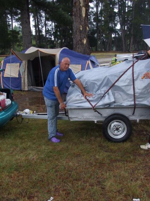 Packing up their tent site at the Albert Town Camping Ground yesterday are (from left) James...