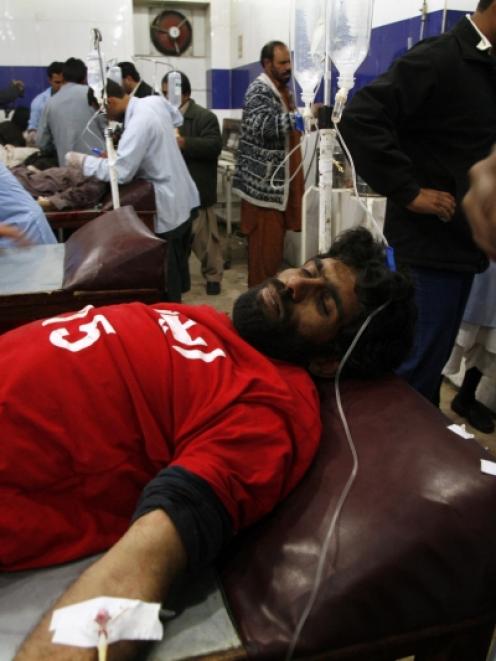 An injured rescue worker receives treatment in a hospital after the second bomb blast in Quetta....