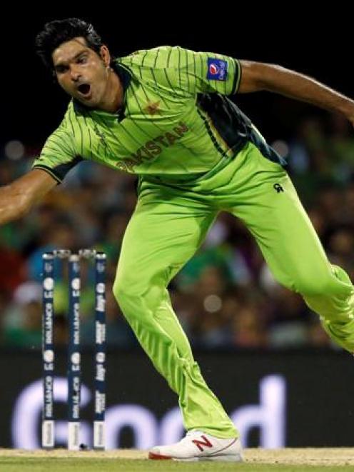 Pakistan's Mohammad Irfan stretches to field a ball while bowling against Zimbabwe in March....