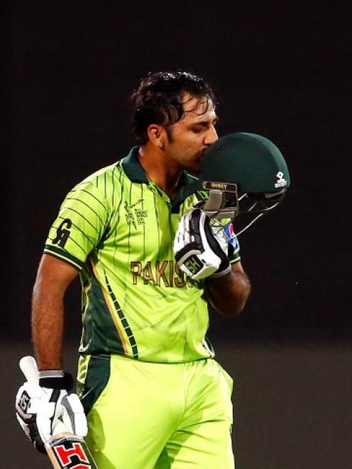 Pakistan's Sarfraz Ahmed kisses his helmet as he celebrates reaching his century against Ireland....