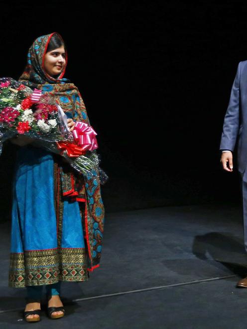 Pakistani schoolgirl Malala Yousafzai, the joint winner of the Nobel Peace Prize, stands with her...