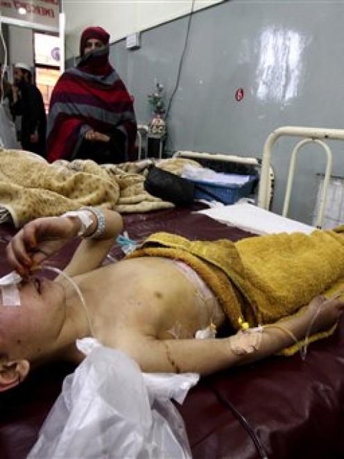 Pakistani student Liaba, front, an injured victim of an explosion, admits at a local hospital in...