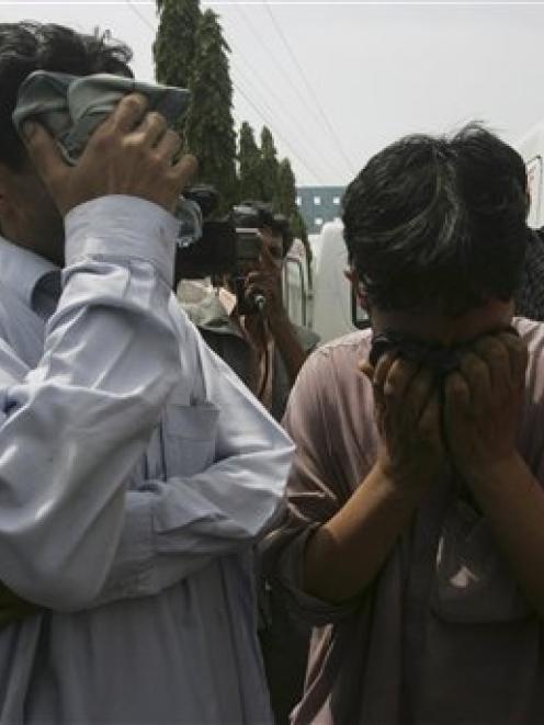 Pakistanis mourn a family member killed in the recent violence. Photo AP