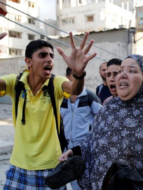 Palestinians flee the scene from what medics said was Israeli shelling, near a market in Shejaia...