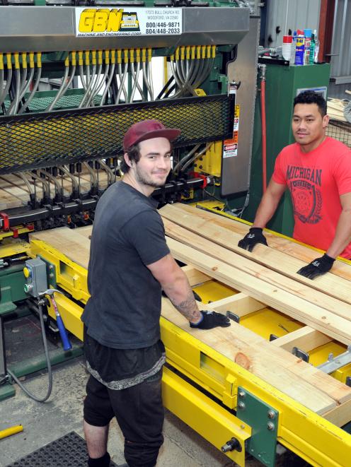 Timpack Industries workers Adam Mutch (left) and Steve Keki operate new machinery, bought by the...